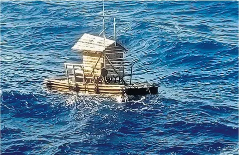  ??  ?? Miles out at sea, Aldi Novel Adilang, 19, is spotted shortly before his rescue, below, aboard his lamp keeper’s hut, which came adrift from its moorings in high winds off Indonesia