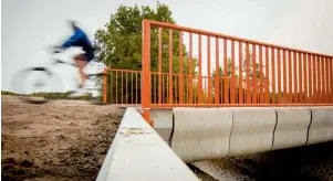  ?? AFP ?? A cyclist rides over the bridge after its opening in Gemert, The Netherland­s, on Tuesday. —