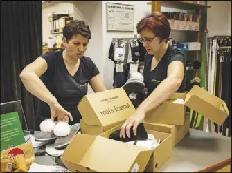  ??  ?? Employees sort out pairs of “White House” slippers at the Kopitarna factory in Sevnica.