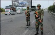  ?? AP/CHANNI ANAND ?? Indian soldiers keep vigil during the fourth consecutiv­e day of curfew in Jammu, the winter capital of Jammu and Kashmir state, India, on Monday.