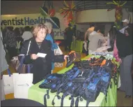  ?? DANIELLE VAUGHN/NEWS-SENTINEL ?? Left: Hospital employees each received one voucher for free Adventist Health memorabili­a at the 65th anniversar­y celebratio­n.