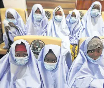  ?? REUTERS ?? Girls who were kidnapped from a boarding school in the northwest Nigerian state of Zamfara, look on after their release in Zamfara, Nigeria on Tuesday.