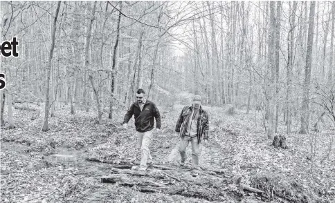  ??  ?? James Morelli and Edwin Moses of Origis Energy walk through Charles County, Maryland, land on Feb 14 and (below) Edwin Moses of Origis Energy goes over a map of wooded Charles County, Maryland, land on Feb 14. — WP–Bloomberg photos by Mary F. Calvert.