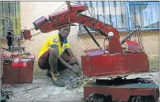  ??  ?? INVENTIVE CREATION: Mpho Makutu and his battery-powered red robot