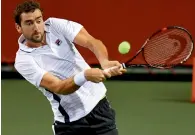  ?? AFP ?? Marin Cilic of Croatia hits a return against Benoit Paire of France during their match in the Japan Open.