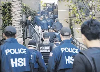  ?? JAE C. HONG Associated Press ?? FEDERAL AGENTS raid an Irvine complex in March in an investigat­ion of three birth tourism businesses catering to Chinese women. Charges have not been filed against the operators of the businesses.