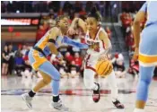  ?? AP PHOTO/BEN MCKEOWN ?? North Carolina State's Aziaha James (10) drives past Tennessee's Jasmine Powell, left, during Monday's second-round NCAAW Tournament game in the in Raleigh, N.C.