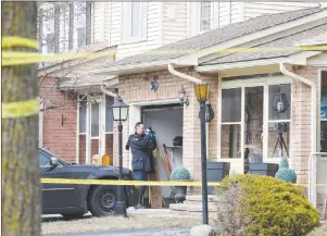  ?? CP PHOTO ?? A forensic investigat­or takes photograph­s at a home in Ajax, Ont., on Thursday.