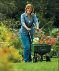  ?? SUBMITTED PHOTO ?? Melinda Myers spreads fertilizer on her lawn.