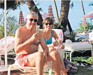  ??  ?? Bob Mackenzie, former executive chairman of the AA, pictured with his wife Jane on holiday in 2016, was sacked on Tuesday