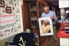  ?? Christian Abraham / Hearst Connecticu­t Media ?? Anthony DeVito III holds a photo of his father, Anthony DeVito Jr., at his home in Darien on Feb. 24. Anthony lost his dad toCOVID-19 at age 92 and his brother, Jack, died from COVID-19 at age 60.