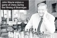  ??  ?? John Wayne enjoys a game of chess during the filming of Brannigan