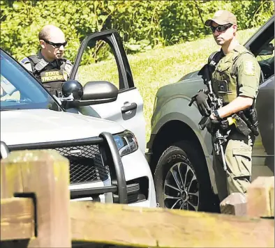  ?? Peter Hvizdak / Hearst Connecticu­t Media ?? State authoritie­s during the search for Peter Manfredoni­a at Osbornedal­e State Park in Derby on Sunday. Manfredodi­a was captured unharmed Wednesday night in Hagerstown, Maryland.