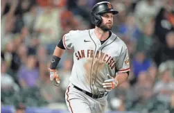  ?? DAVID ZALUBOWSKI/AP ?? San Francisco Giants first baseman Brandon Belt, seen Sept. 24, accepted an $18.4 million qualifying offer to stay with the team.