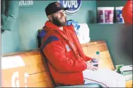  ?? Winslow Townson / Associated Press ?? Red Sox second baseman Dustin Pedroia, sitting in the dugout prior to a game against the Rockies on May 15 at Fenway Park in Boston, will take an “indefinite leave” in his long struggle to recover from knee trouble.