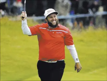  ?? MATT DUNHAM/THE ASSOCIATED PRESS ?? Andrew “Beef” Johnston of England raises his putter to cheers on the 18th green during the third round of the British Open on Saturday at Royal Troon Golf Club in Troon, Scotland. The personable Johnston is alone in fourth place at 5-under-par 208,...