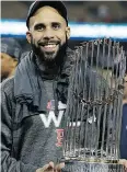  ?? THE ASSOCIATED PRESS ?? David Price holds the championsh­ip trophy Sunday night.
