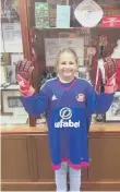  ??  ?? Angel wearing Sunderland goalkeeper Vito Mannone’s matchworn shirt and gloves.