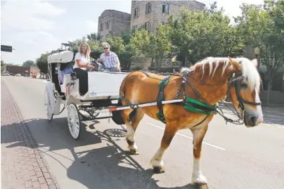  ?? STAFF FILE PHOTO ?? Junebug, a Belgian draft horse, pulls a carriage with driver Vickie LaRose and owner Mark Neal down Market Street in the late 1990s. Junebug died last week at 32.