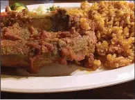  ?? Arkansas Democrat-Gazette/HELAINE R. WILLIAMS ?? Rice, spice and everything nice: Jollof Rice & Stew is served at Kontiki African Restaurant in Alexander.