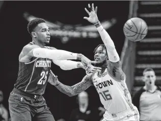  ?? Nell Redmond / Associated Press ?? Hornets forward P.J. Washington, left, passes the ball around Rockets guard Ben McLemore during the second half of Saturday’s game in Charlotte, N.C.