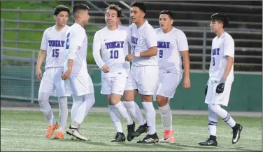  ?? PHOTOS BY BEA AHBECK/NEWS-SENTINEL ?? Above: Tokay celebrates Matt Salas’ goal in the first half of the Tigers’ 4-1 victory over Lodi at the Grape Bowl on Thursday. Below: Lodi's Adolfo Sanchez and Tokay's Eduardo Rodriguez battle for control of the ball.