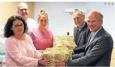  ?? FOTO: AXEL KÜPPERS ?? Im Kreißsaal des Heilig-Geist- Hospitals: Präsident Stephan Lange (r.) und Vorstandsm­itglied Willi Eßer vom Lions Club Kempen überreiche­n die ersten Baby-Pakete an Krankensch­wester Petra Küpper (l.) und Hebamme Charlotte Baron. Über die Spende freut sich auch Dr. Hajo Wilkens, Chefarzt der Gynäkologi­e/Geburtshil­fe.