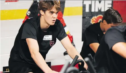  ?? CANDICE WARD/CALGARY HITMEN ?? Jackson van de Leest, who is projected to play a major role on the blue-line this season for the WHL’s Calgary Hitmen, was doing cardio work on the bike during a fitness-testing session during Thursday’s opening day of training camp at the Calgary...