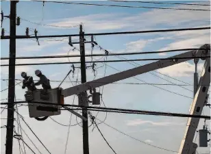  ?? Elizabeth Conley/Staff photograph­er ?? CenterPoin­t linemen try to get power lines fixed following a Jan. 24 tornado in Deer Park. Union workers, including those who keep the lights on, vote today on whether to strike.