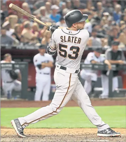  ?? CHRISTIAN PETERSEN — GETTY IMAGES ?? Giants rookie Austin Slater delivers his second run-scoring double of the game against Arizona during the seventh inning.