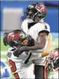  ?? Nic Antaya Getty Images THE BUCCANEERS’ ?? Chris Godwin celebrates a touchdown with Tom Brady against Detroit.