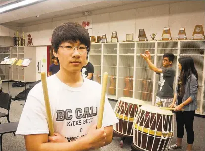  ?? R. Clayton McKee / For the Chronicle ?? Memorial High School senior Sehwa “Nick” Kang will attend Johns Hopkins University in fall. Practicing drum with him are ensemble mates Jin Lee, a junior, and Pamela Liou, a senior.