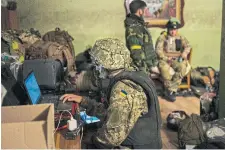  ?? BERNAT ARMANGUE THE ASSOCIATED PRESS ?? A Ukrainian soldier checks drone footage in a temporary base near Kharkiv, which endured weeks of intense Russian shelling.