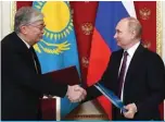  ?? ?? MOSCOW: Russian President Vladimir Putin shakes hand with his Kazakhstan’s counterpar­t KassymJoma­rt Tokayev after a signing ceremony in the Kremlin on Nov 28, 2022. — AFP