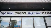  ?? GRANT BLACK/FILES ?? A banner hangs off a downtown building in High River in 2014, a year after the catastroph­ic flood.