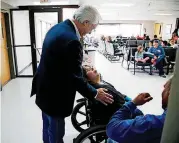  ?? [PHOTO BY JAMES GIBBARD, TULSA WORLD FILE PHOTO] ?? In this 2016 file photo, Cherokee Nation Principal Chief Bill John Baker greets a patient while touring the tribe’s W.W. Hastings Hospital in Tahlequah. The Cherokee Nation says its health care system hasn’t yet been affected by a federal government shutdown.