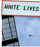  ??  ?? Flypast: The plane trailing its banner zooms over the Etihad Stadium during the match