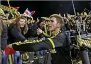  ?? FRED SQUILLANTE — THE ASSOCIATED PRESS ?? Crew midfielder Wil Trapp celebrates with fans after the Crew won their MLS playoff game against the Montreal Impact at Mapfre Stadium in Columbus. The owner of the Crew SC says the team will move to Austin, Texas, unless a new stadium is built in...