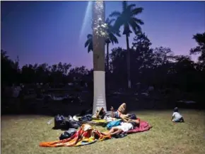  ?? VICTORIA RAZO/AFP ?? Central American migrants –taking part in a ‘caravan’ called ‘Migrant Viacrucis’ – rest in a field in Matias Romero, Oaxaca state, Mexico, on Monday.