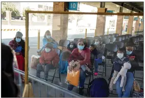  ?? (The New York Times/Ilana Panich-Linsman) ?? Mothers and children wait to be tested for the coronaviru­s Saturday in Brownsvill­e, Texas, after being released by Customs and Border Protection.