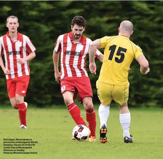  ?? Photo by Michelle Cooper Galvin ?? Chris Egan, Mastergeeh­a in possession challenged by Martin Sweeney, Classic FC in the FAI Junior Cup at Mastergeeh­a Killarney on Sunday