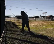  ?? ?? The Eagle Pass municipal golf course sits on the Texas side of the Rio Grande, lined with shipping containers that are topped with concertina wire. Fernando Bonilla, above, hit one of the containers in a recent game.