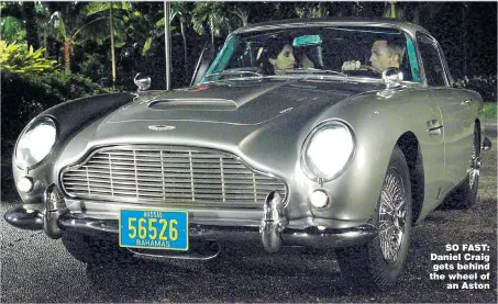  ??  ?? SO FAST: Daniel Craig gets behind the wheel of an Aston