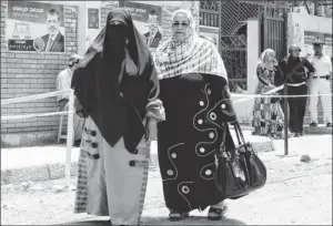  ?? Afp/getty Images ?? Rigid roles in society: Egyptian women walk outside a polling station in the Mediterran­ean city of Alexandria on May 24. Recent revolution­ary movements have done little for women’s rights.