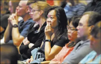  ?? Steve Lundy The Associated Press ?? Audience members listen Aug. 8 as it was announced at Willow Creek Community Church in South Barrington, Ill., that lead pastor Heather Larson is stepping down in the wake of sexual harassment allegation­s against church founder Bill Hybels.