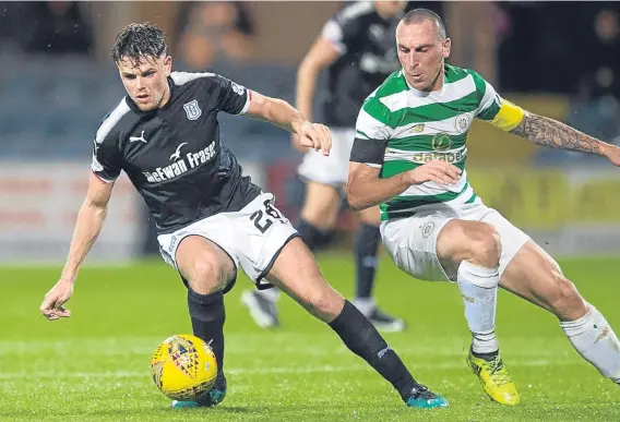  ??  ?? Dundee midfielder Lewis Spence — pictured above in Betfred Cup action against Celtic — will be going under the knife to sort an ankle injury.