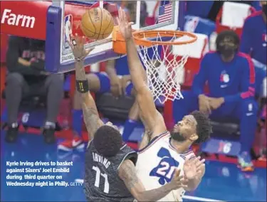  ?? GETTY ?? Kyrie Irving drives to basket against Sixers’ Joel Embiid during third quarter on Wednesday night in Philly.