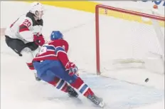  ?? Graham Hughes / The Canadian Press via AP ?? New Jersey’s Blake Coleman (20) scores an empty-net goal as Shea Weber defends on Thursday night at Bell Centre.