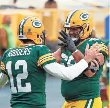  ?? AP ?? Quarterbac­k Aaron Rodgers has plenty of reason to celebrate with David Bakhtiari, as the left tackle signed a four-year, $105.5 million extension.