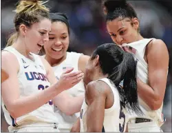  ?? SEAN D. ELLIOT/THE DAY ?? UConn’s Katie Lou Samuelson, left, Napheesa Collier, back center, and Olivia Nelson-Ododa, right, make a joke of dusting off teammate Crystal Dangerfiel­d after Dangerfiel­d was fouled on a drive to the basket against South Carolina on Monday night. UConn won 97-79.